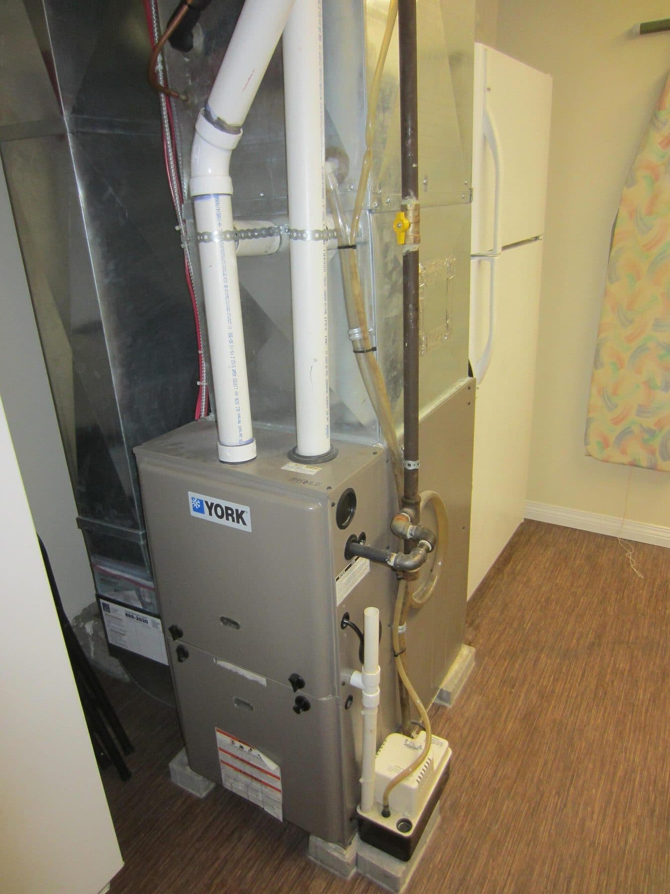 Central HVAC furnace and return in a utility closet — the kind of unit that takes a rectangular pleated filter